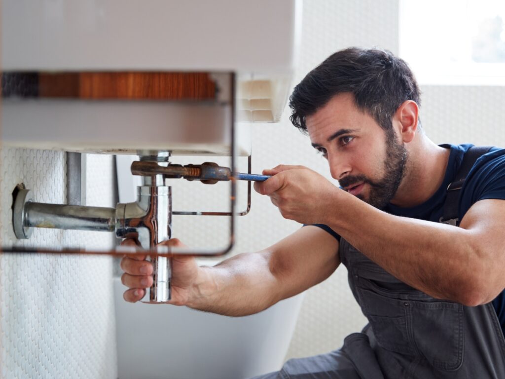 A quick plumbing repair in Centereach, NY. A plumber fixes a sink leak.